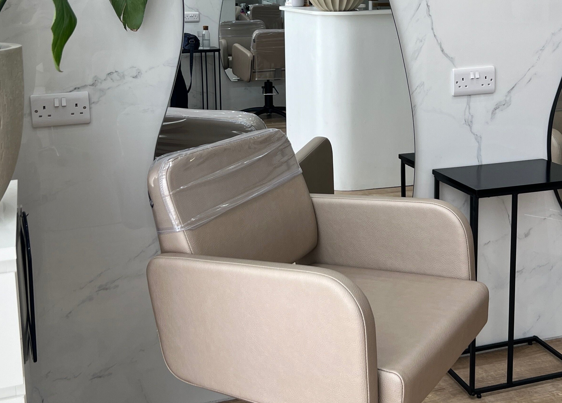 Elegant salon chair and decor at The Strand Designs in Kenley, England, GB.