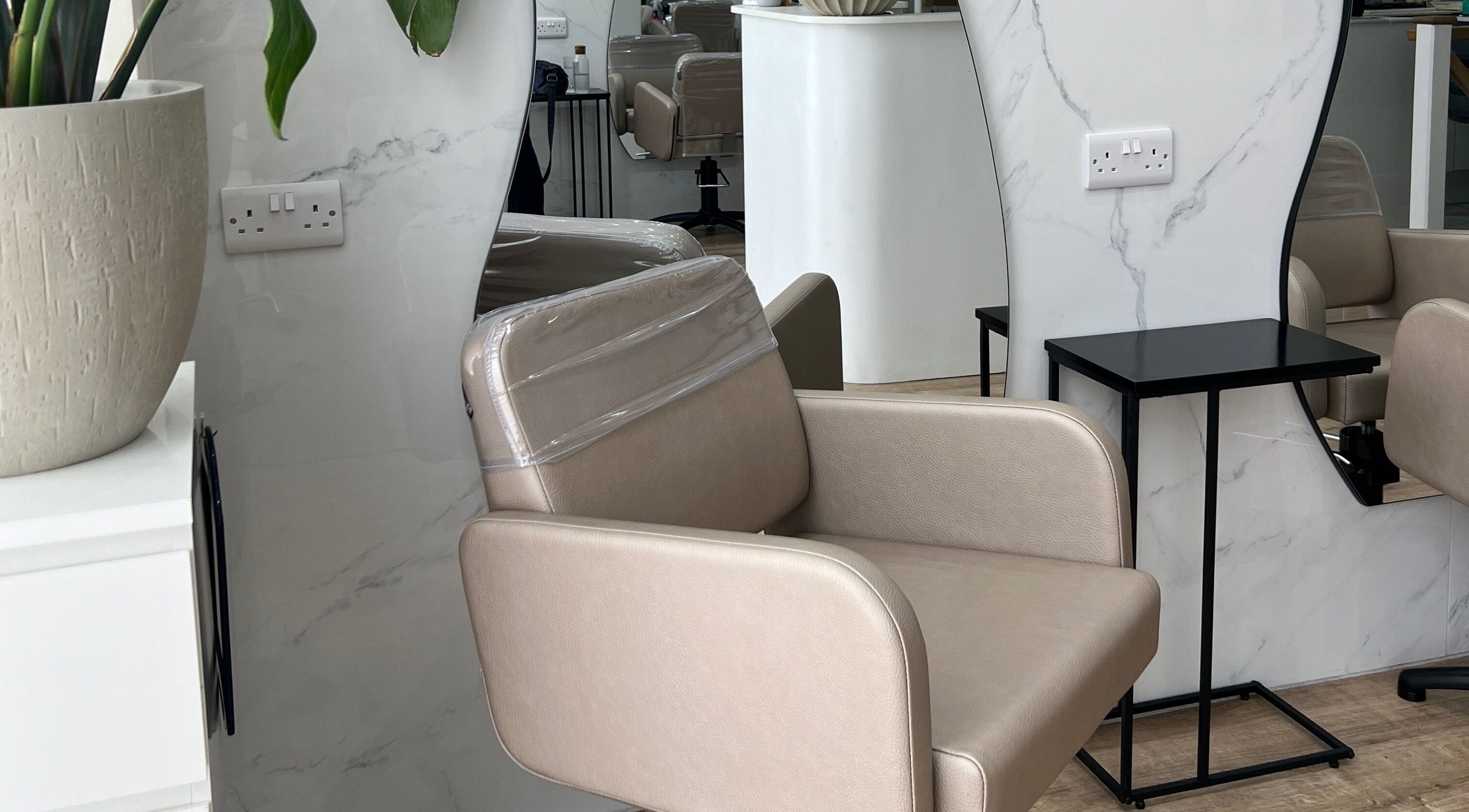 Elegant salon chair and decor at The Strand Designs in Kenley, England, GB.