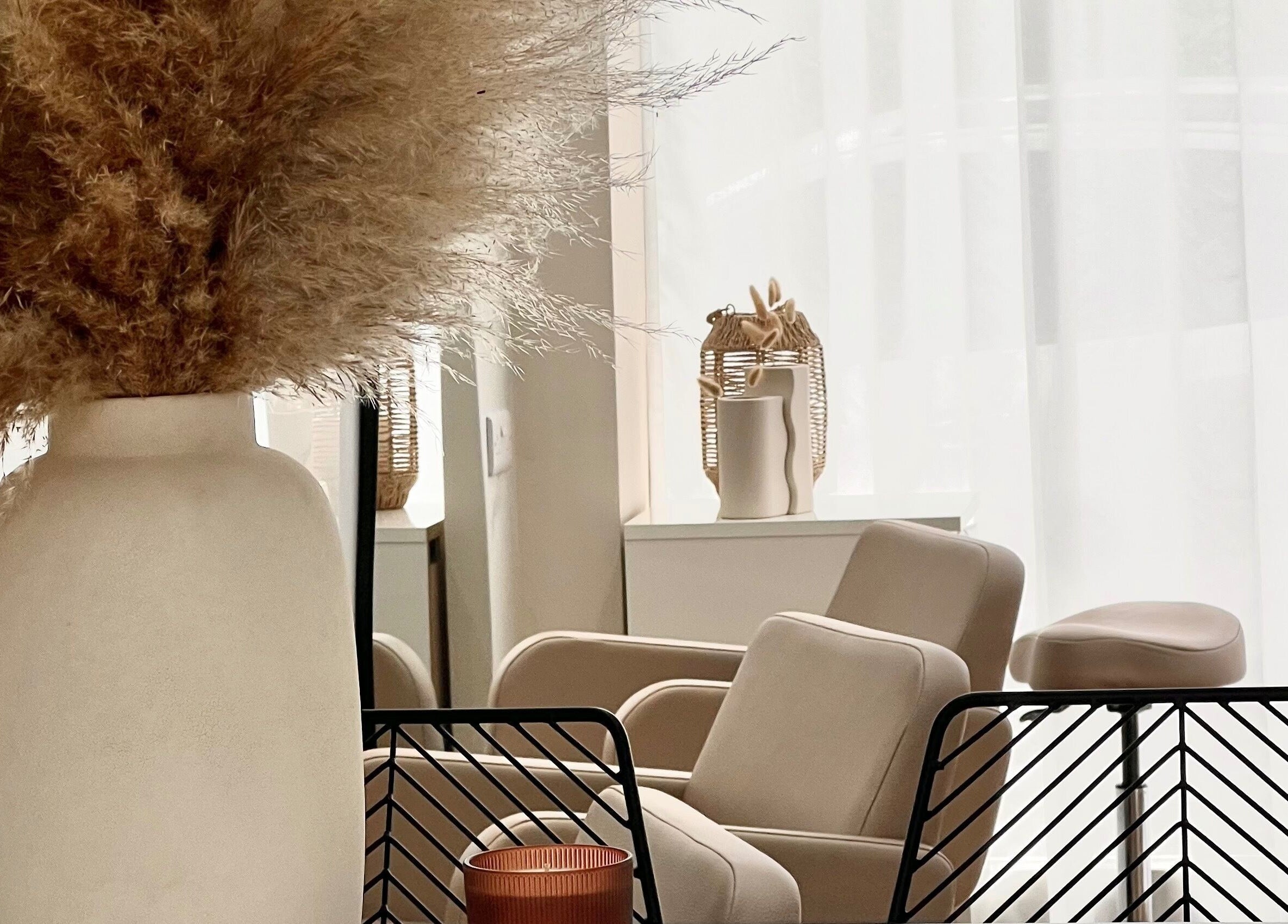 Elegant seating area at The Strand Designs, Kenley, England, GB with plush chairs and decorative elements.