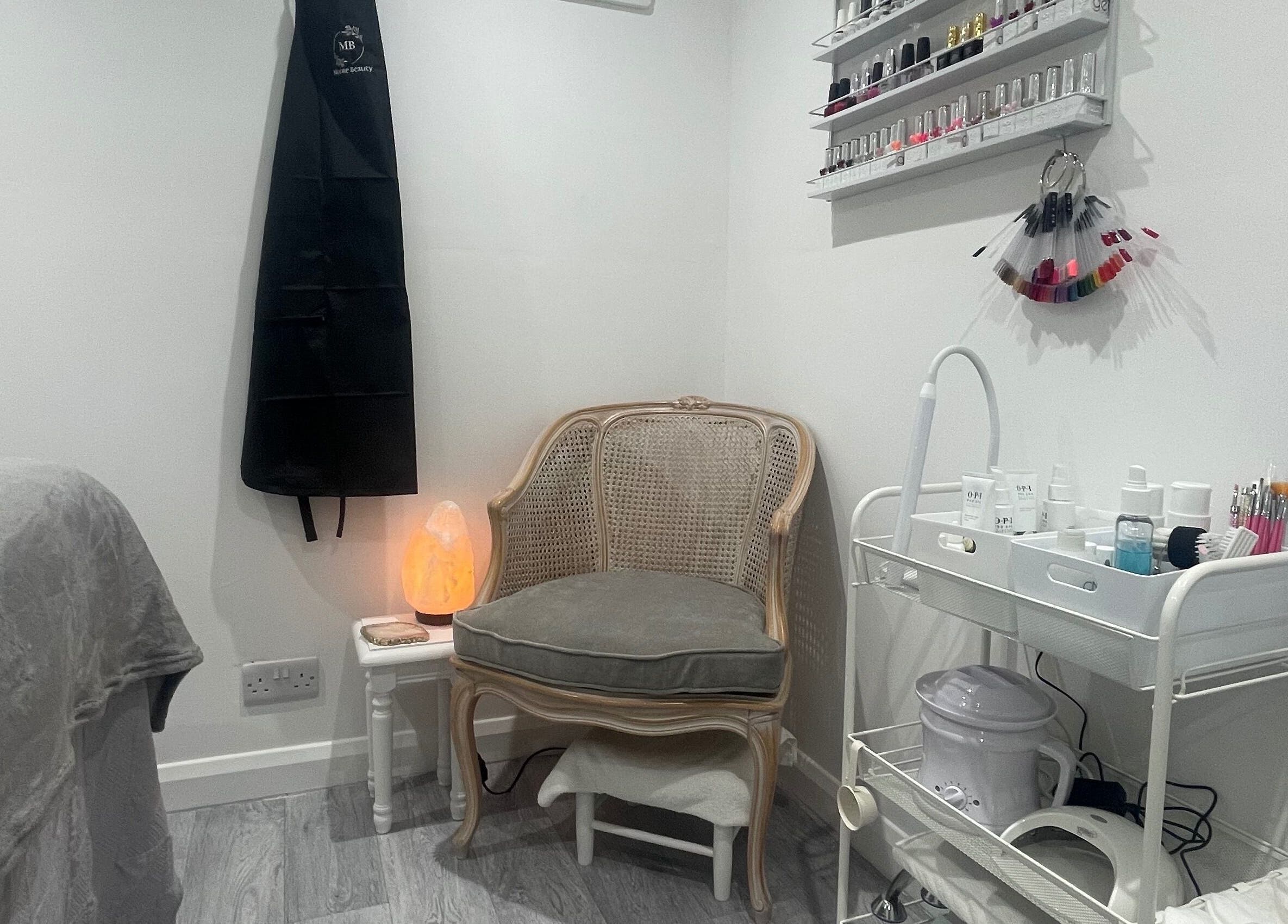 Cozy corner of Moore Beauty in Knaphill, England, featuring a chair, nail polishes, and spa tools.