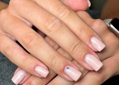 Elegant nail art showcasing glossy nude nails with a gem, By Kadie in Throckley, England, GB.
