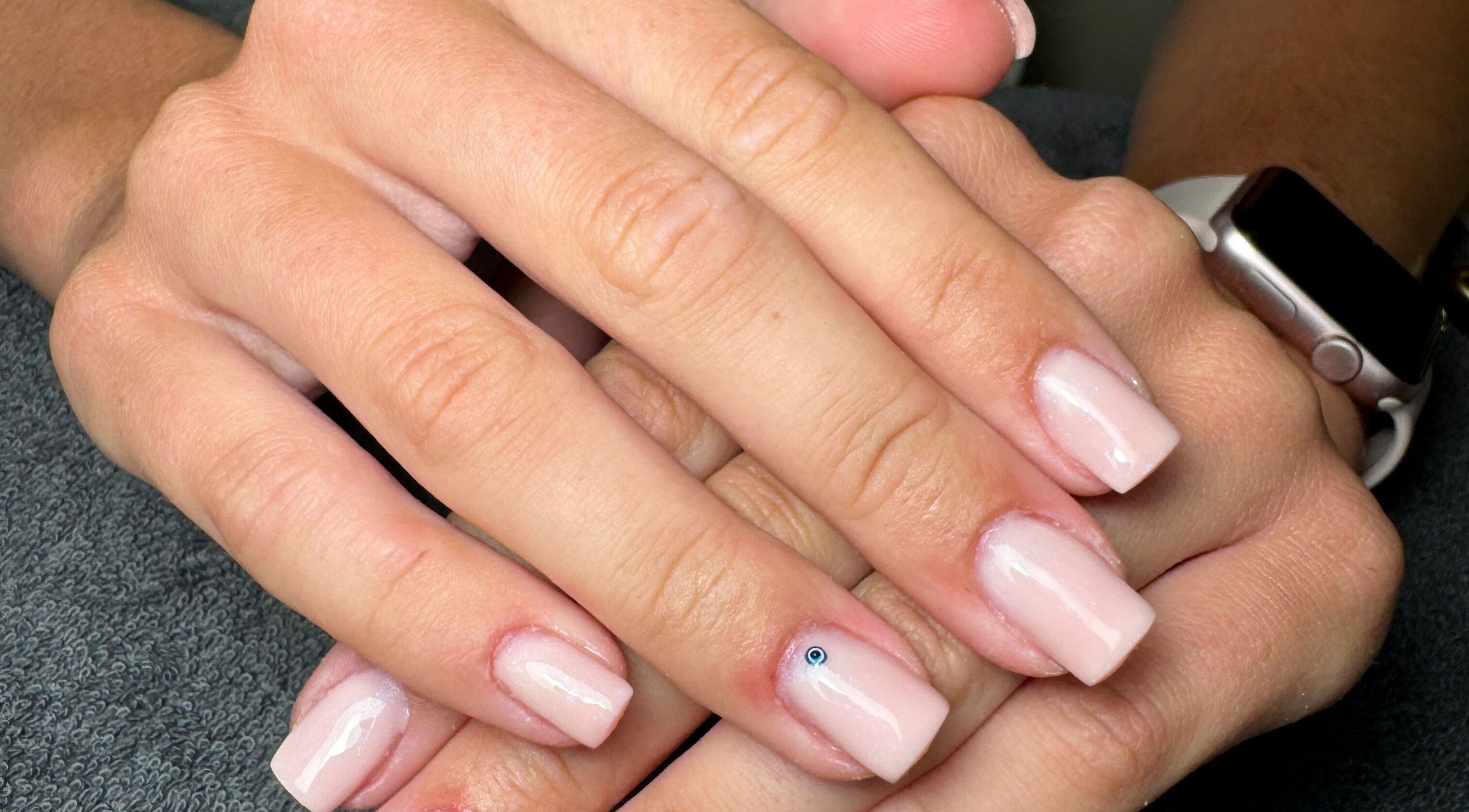 Elegant nail art showcasing glossy nude nails with a gem, By Kadie in Throckley, England, GB.