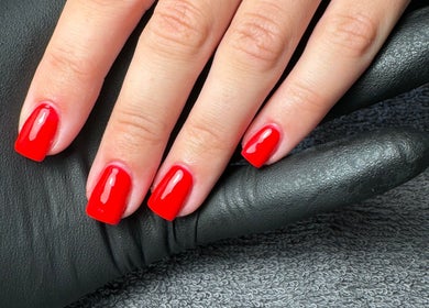 Vibrant red manicure from By Kadie in Throckley, England, GB, showcasing flawless nail artistry.