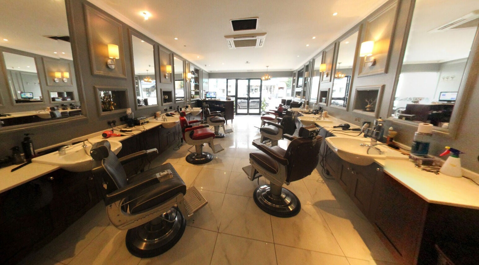 Elegant barber chairs at The Stag - Mill Hill, a stylish salon in London, England, GB.