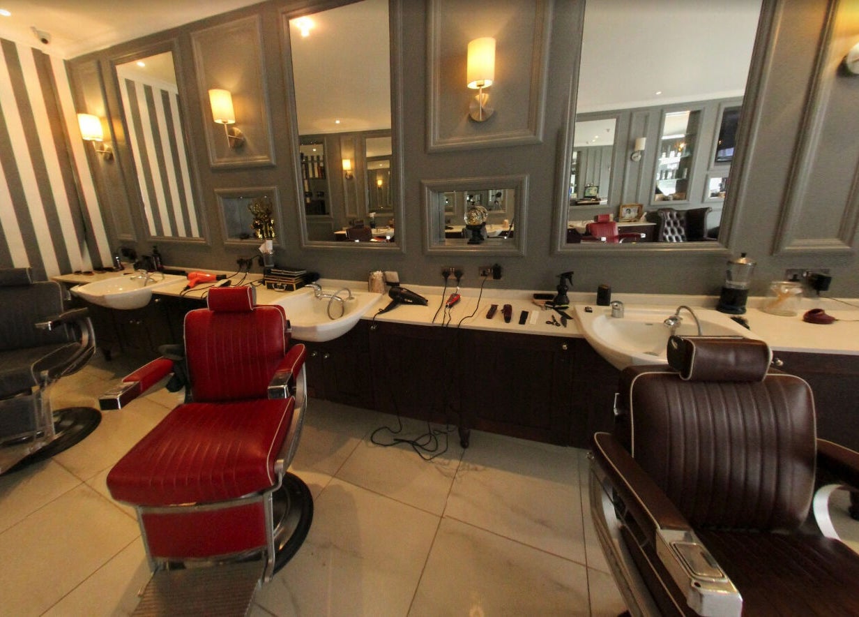 Elegant barber chairs at The Stag - Mill Hill, London, England, GB with stylish mirrors and lighting.