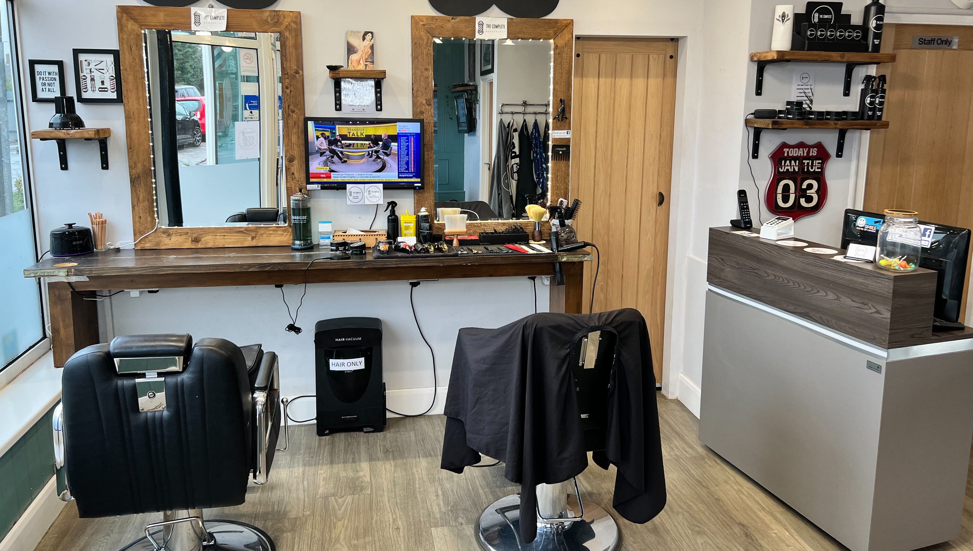 Interior of The Complete Barber Shop Cowfold, featuring sleek chairs and stylish decor in Cowfold, England, GB.