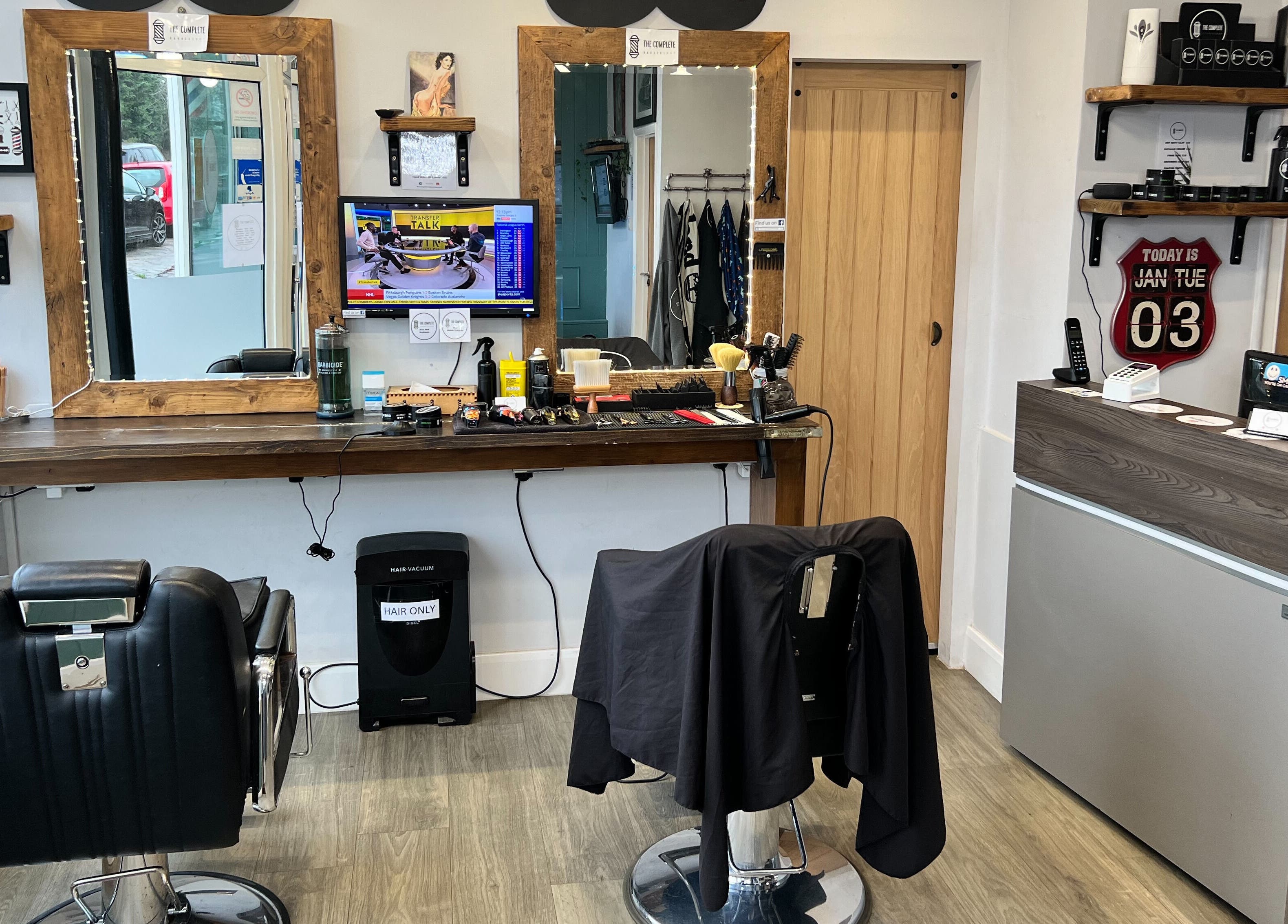 Interior of The Complete Barber Shop Cowfold, featuring sleek chairs and stylish decor in Cowfold, England, GB.