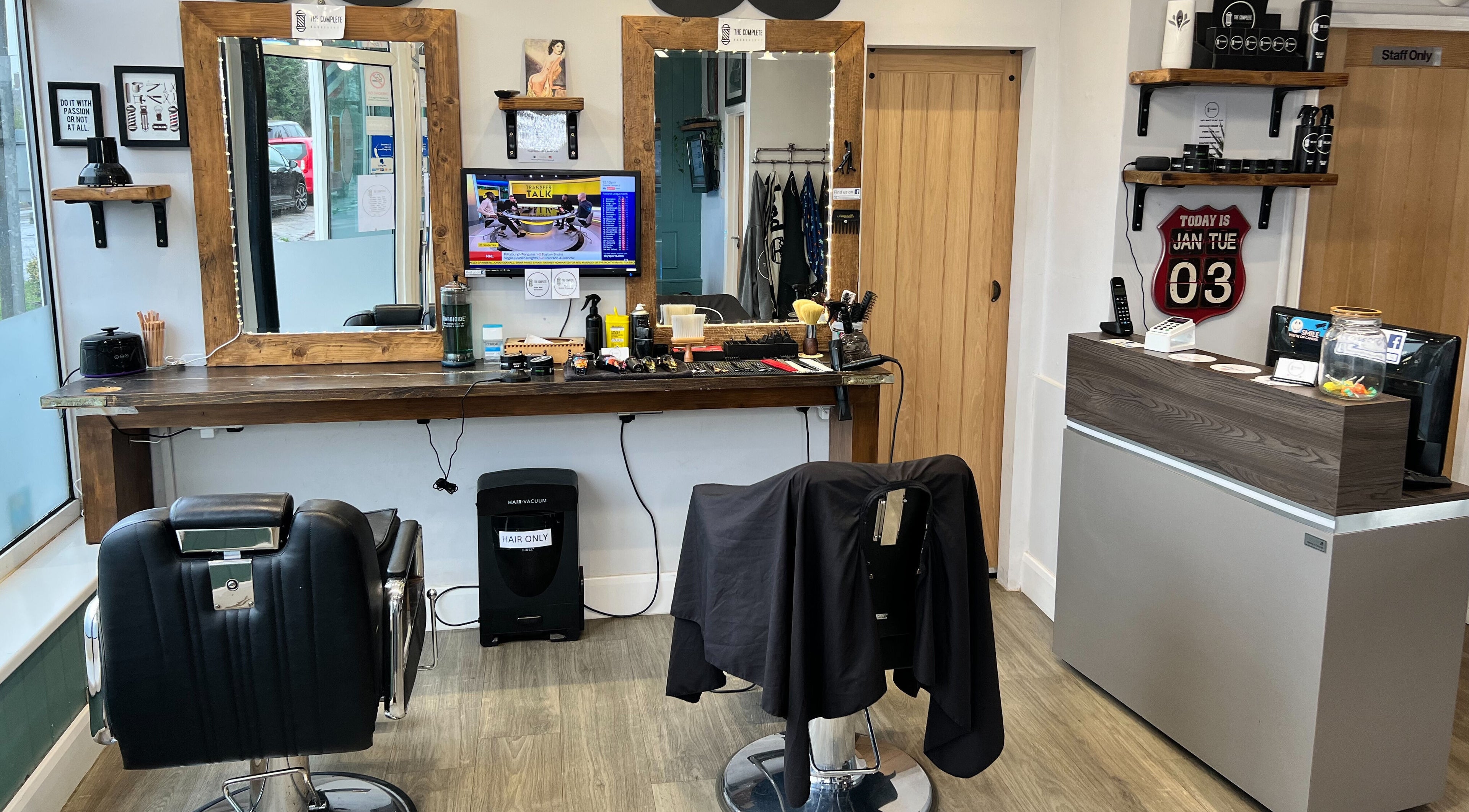 Interior of The Complete Barber Shop Cowfold, featuring sleek chairs and stylish decor in Cowfold, England, GB.