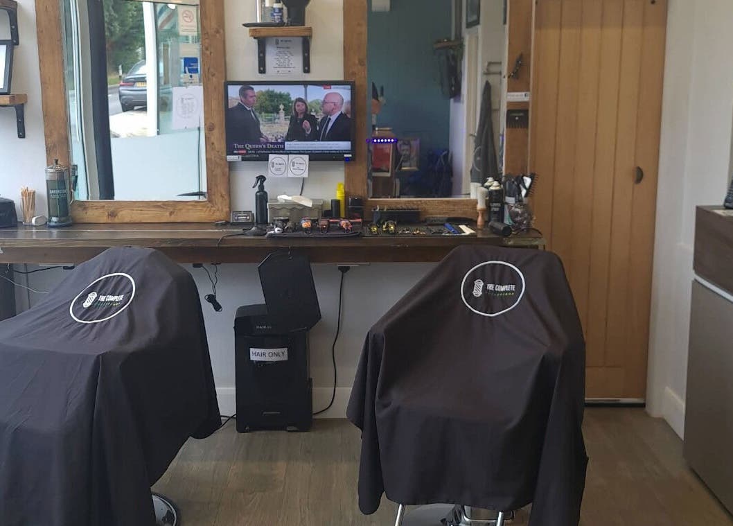 Chic interior of The Complete Barber Shop Cowfold, featuring dual barber chairs, Cowfold, England, GB.