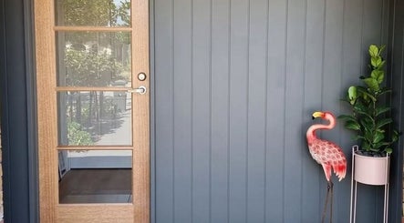 Elegant wooden door with flamingo decor at Polished Beautique, Hallett Cove, South Australia, AU.
