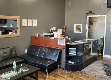 Reception area of Tat2Guru - Dream Chaser Tattoo LLC in Lexington, Kentucky, US showing modern seating and decor.
