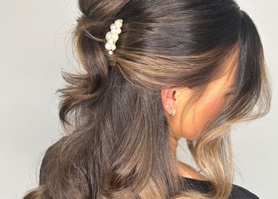 Elegant hairstyle with pearl clip at Amy Curran Hair and Makeup, Altrincham, England, GB.