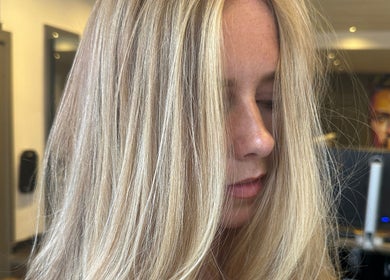 Blonde hair transformation at Amy Curran Hair and Makeup, Altrincham, England, GB in chic salon setting.