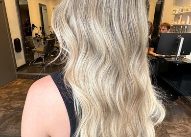 Stunning blonde hairstyle at Amy Curran Hair and Makeup, Altrincham, England, GB, showcasing wavy layers.