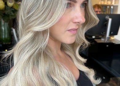 Woman with blonde waves at Amy Curran Hair and Makeup, Altrincham, England, GB salon.