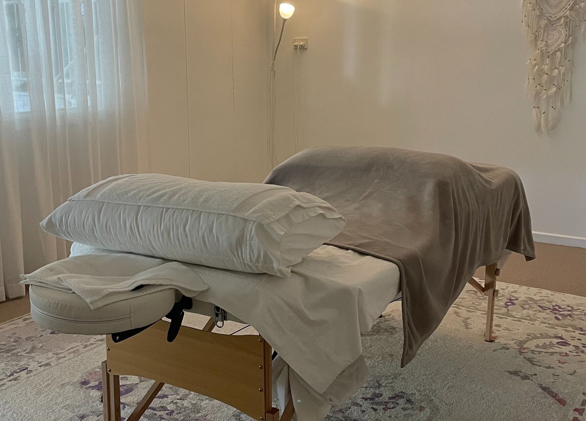 Relaxing massage table at The Biofield Body - Byron Bay, New South Wales, AU with soft lighting and decor.