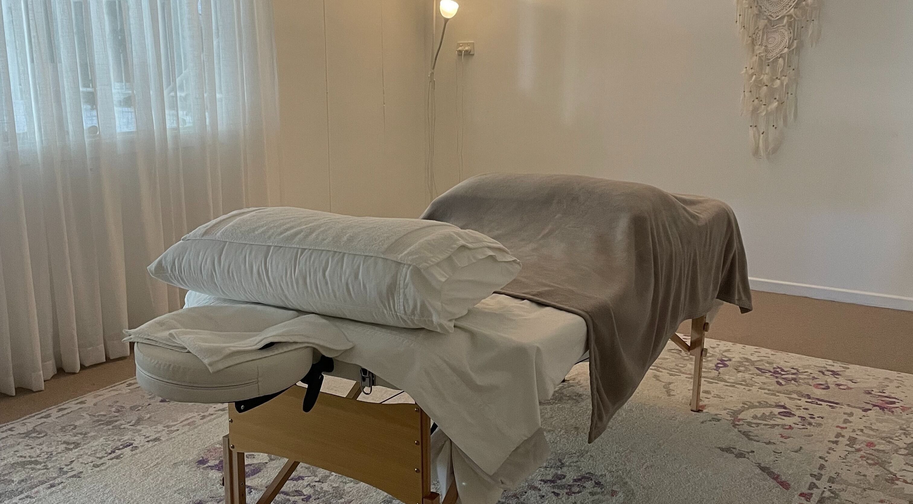 Relaxing massage table at The Biofield Body - Byron Bay, New South Wales, AU with soft lighting and decor.