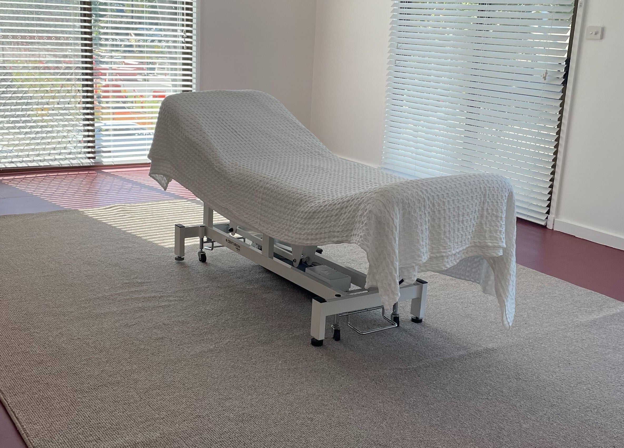 A serene treatment room at The Biofield Body - Byron Bay, featuring a massage table in Byron Bay, New South Wales, AU.