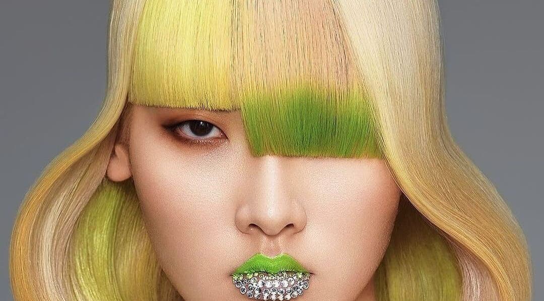 Bold green and yellow hairstyle with rhinestone lips at Mila Hair Spa, Bali, Bali, ID.