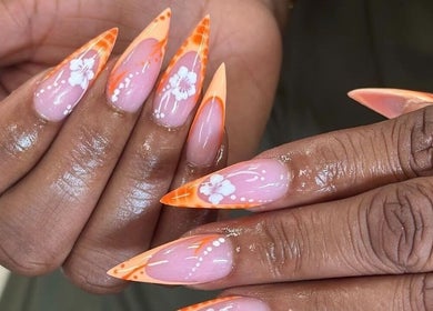 Floral orange nail design at 24K NAIL SPA, Arlington, Texas, US.