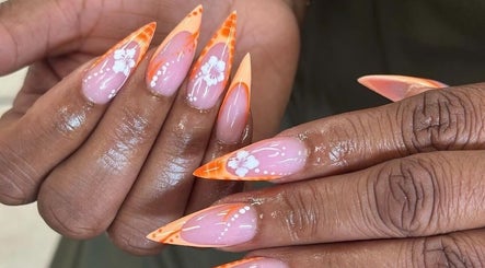 Floral orange nail design at 24K NAIL SPA, Arlington, Texas, US.