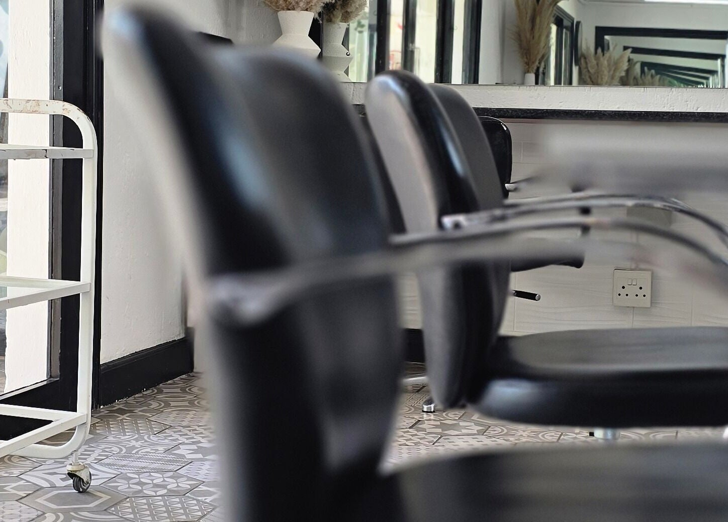 Modern seating at Hair On View, Boksburg, Gauteng, ZA, showcasing sleek black chairs and stylish decor.