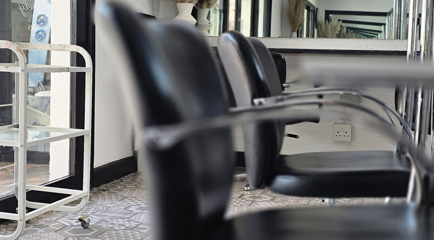 Modern seating at Hair On View, Boksburg, Gauteng, ZA, showcasing sleek black chairs and stylish decor.