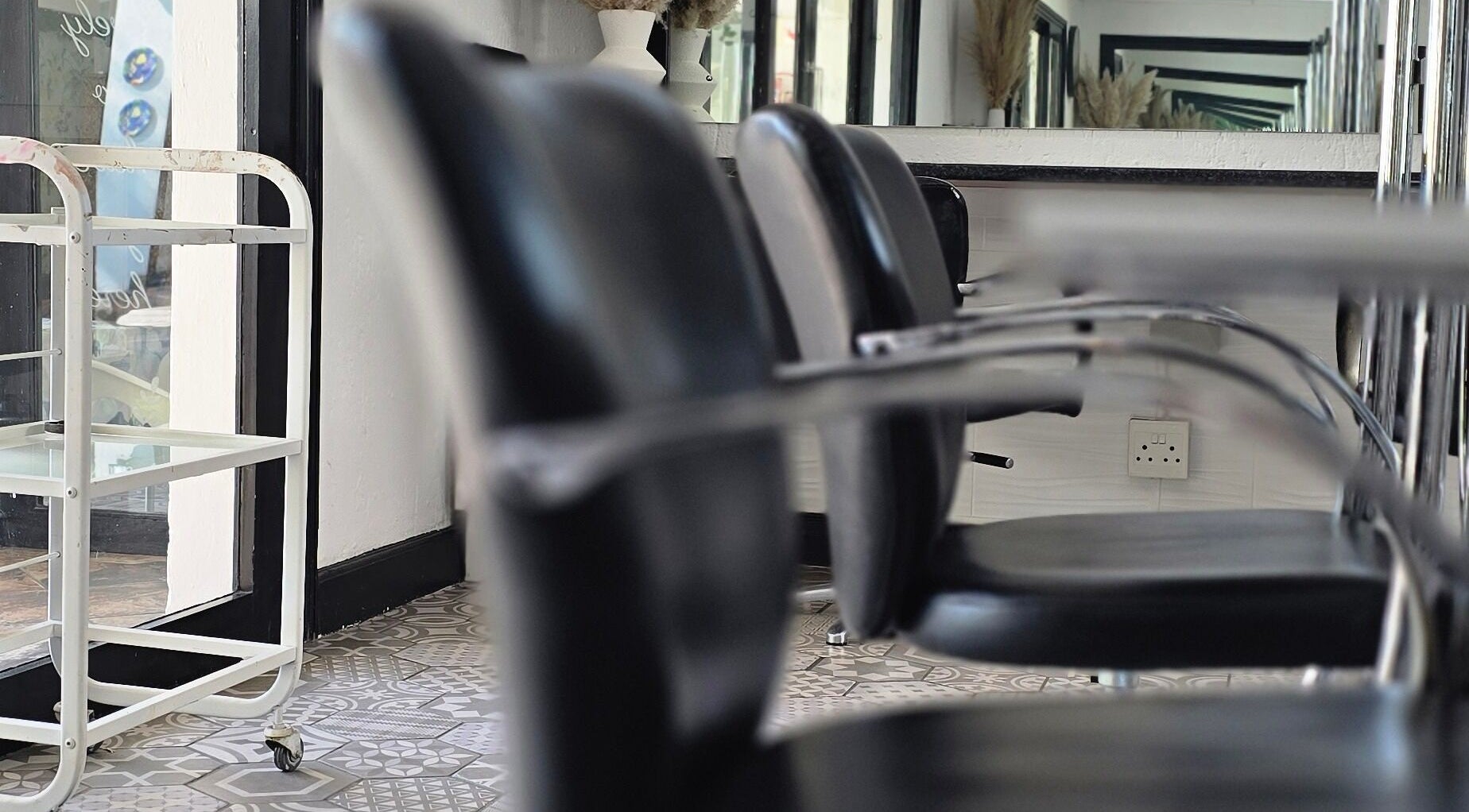 Modern seating at Hair On View, Boksburg, Gauteng, ZA, showcasing sleek black chairs and stylish decor.