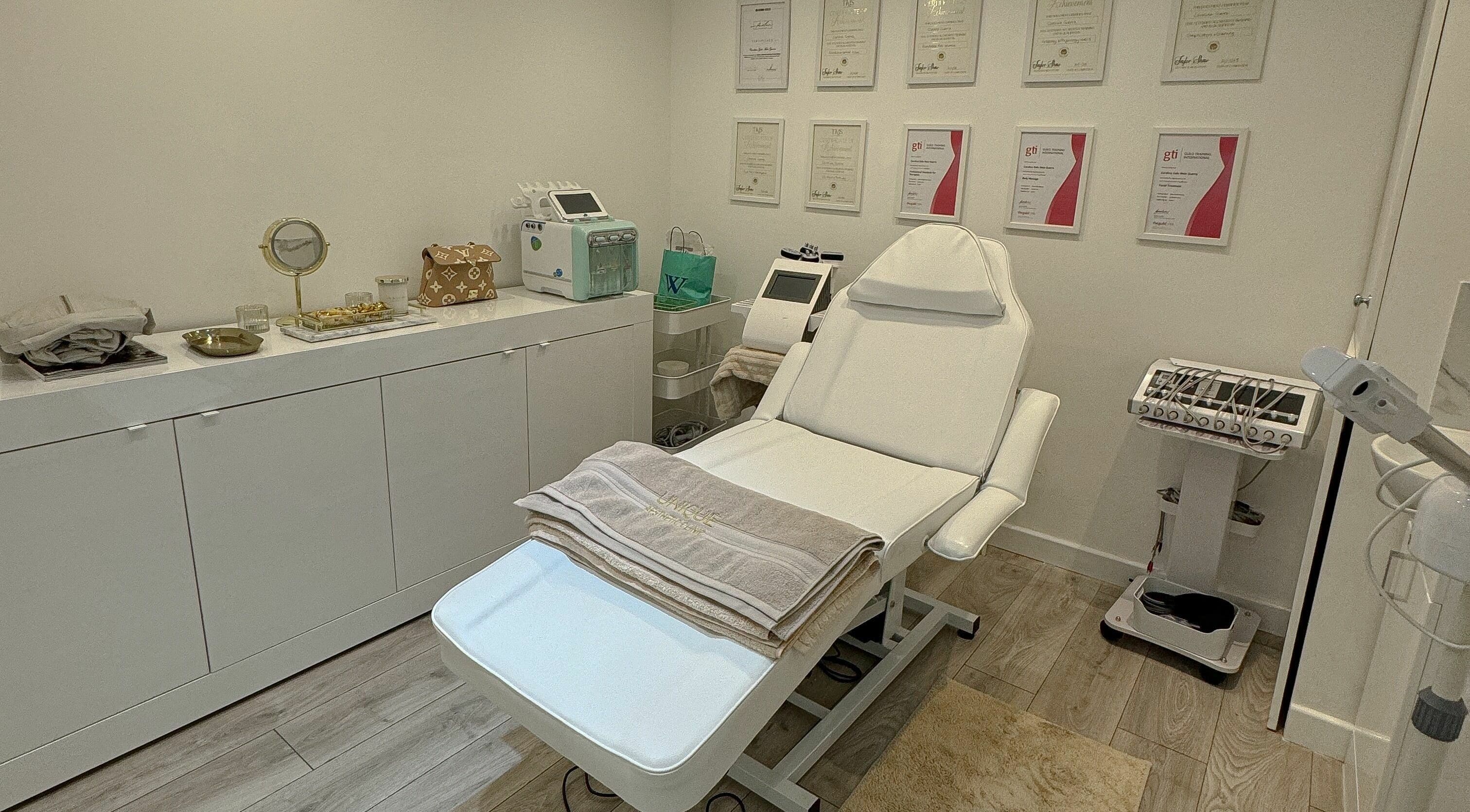 Modern treatment room at Unique Aesthetic Clinic, London, England, GB, with plush chair and advanced equipment.