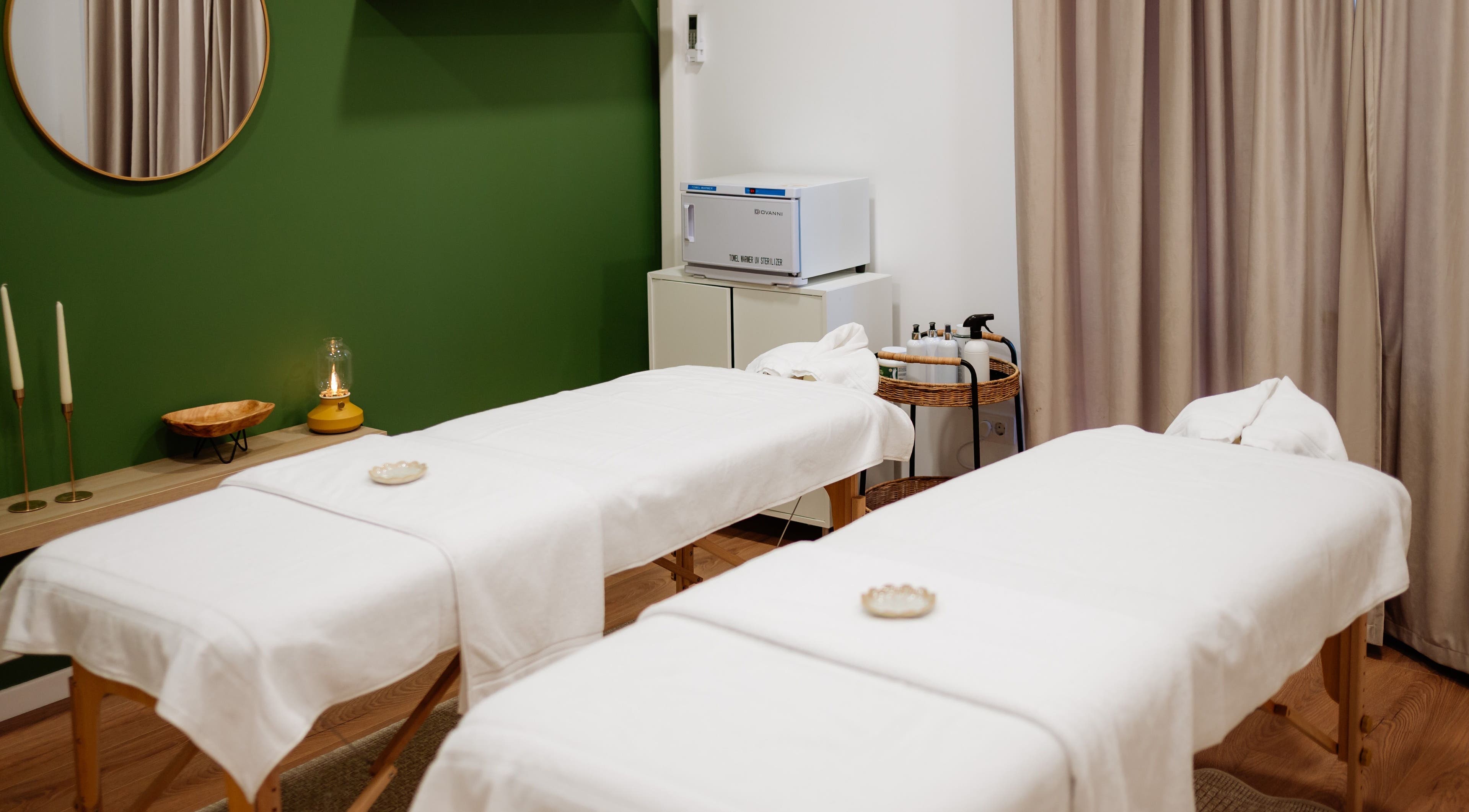 Sala de masaj la Harmony Wellness Cotroceni, București, București, RO, cu paturi albe și decor elegant.