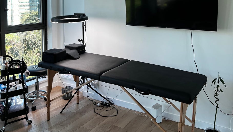 Calm and inviting treatment room at GlowBrows Phi, Vancouver, British Columbia, CA, featuring a massage table.