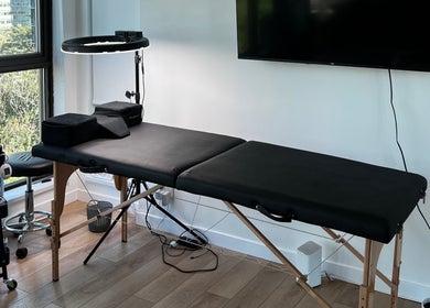 Calm and inviting treatment room at GlowBrows Phi, Vancouver, British Columbia, CA, featuring a massage table.