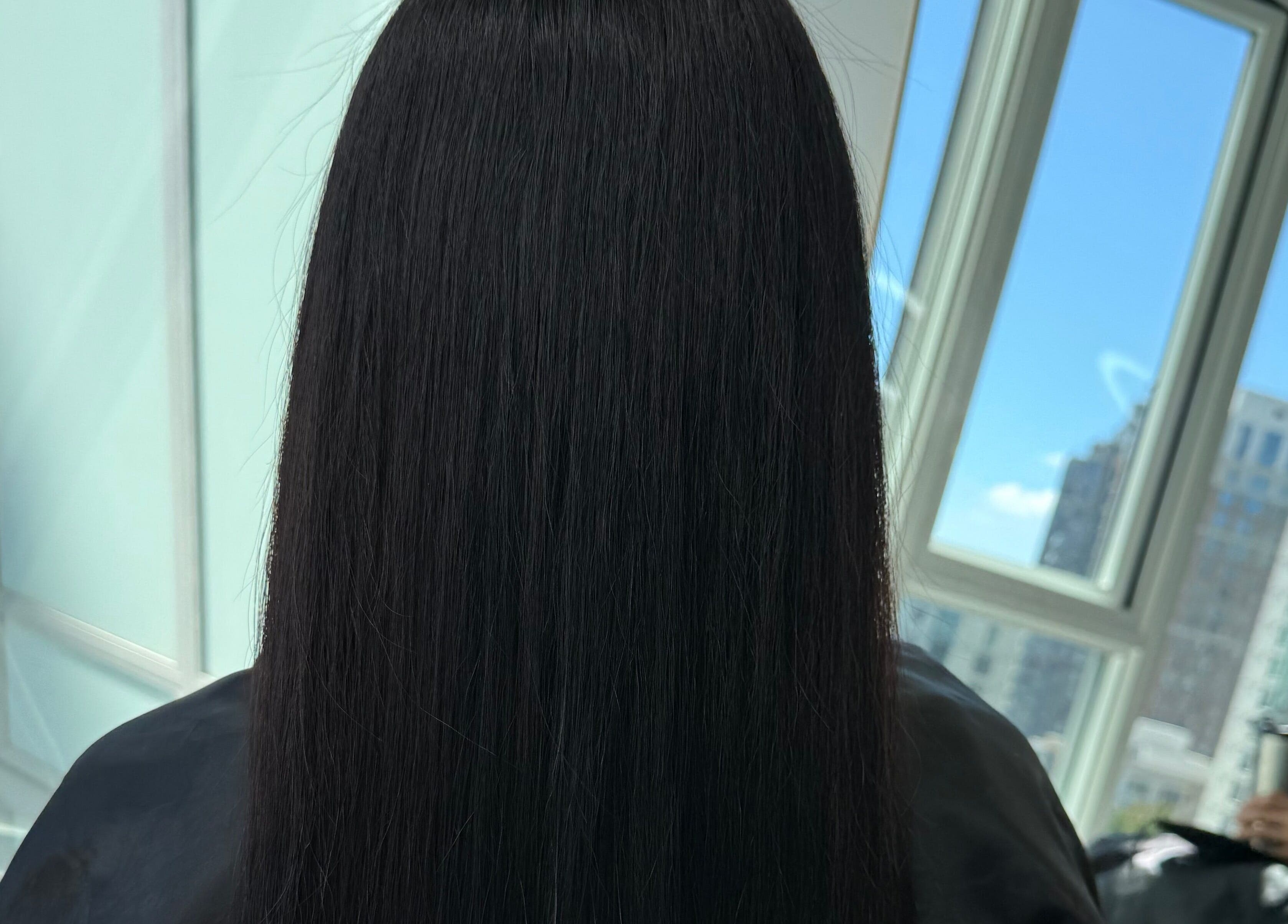 Smooth, straight hair at GlowBrows Phi, Vancouver, British Columbia, CA, framed by large sunny windows.
