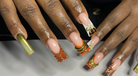 Intricate nail art design at CZR Nails, London, England, GB featuring gold embellishments and vibrant colors.