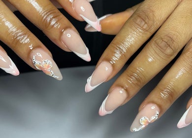 Stylish butterfly nail art at CZR Nails, London, England, GB. Perfectly manicured design with soft pink tones.