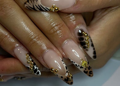 Stylish animal print and gold nail design at CZR Nails, London, England, GB.