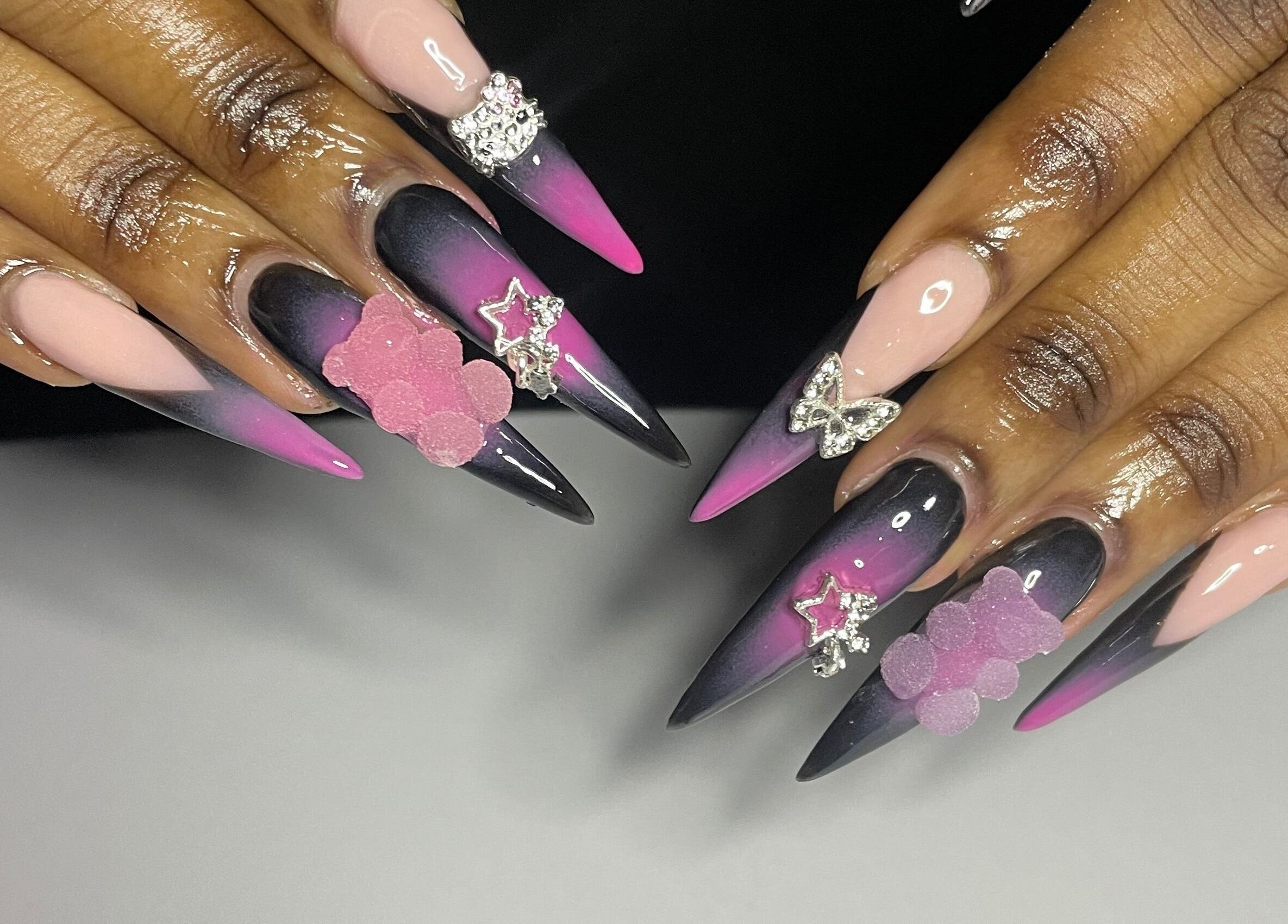 Chic, embellished ombre nails at CZR Nails, London, England, GB, featuring pink and black gradient designs.