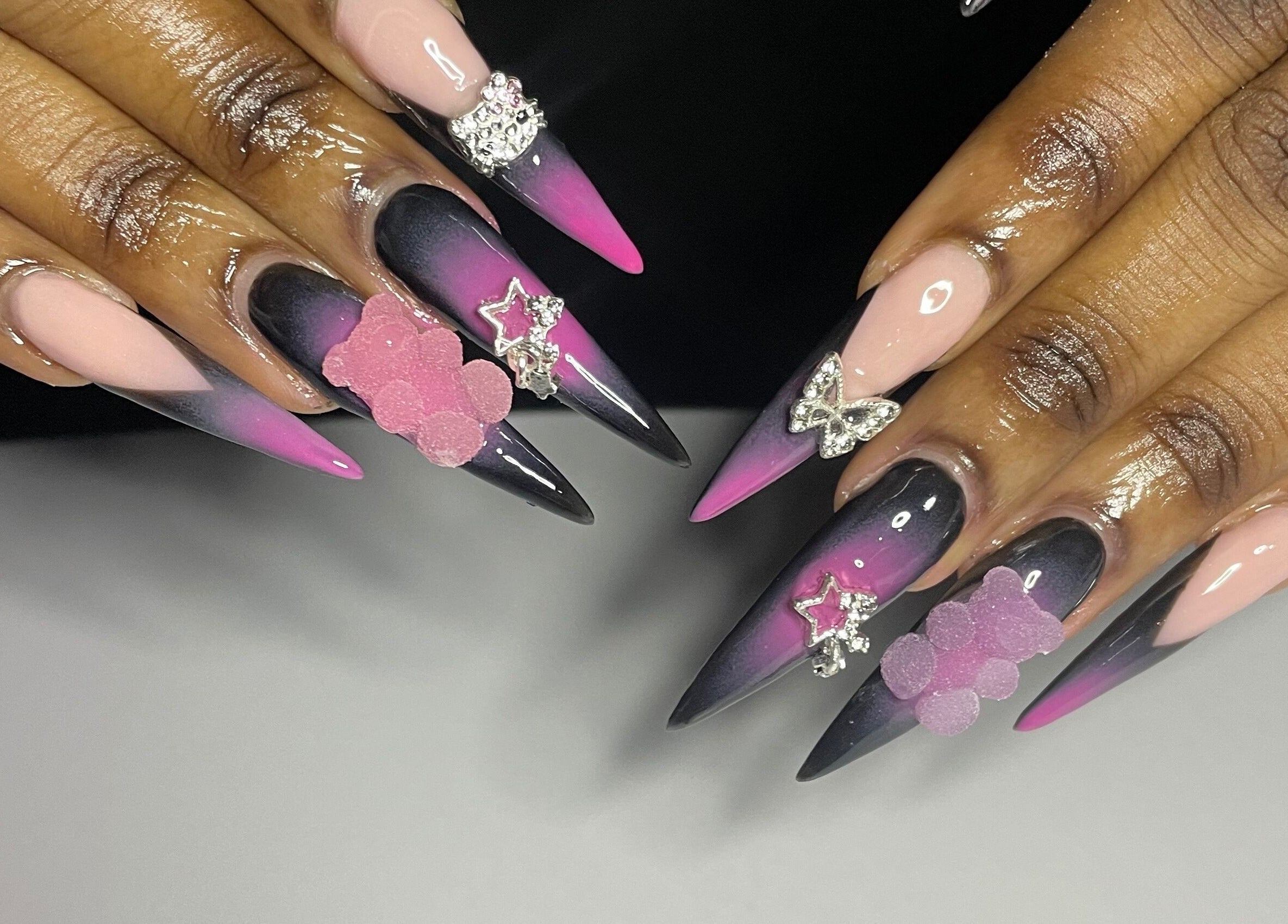 Chic, embellished ombre nails at CZR Nails, London, England, GB, featuring pink and black gradient designs.
