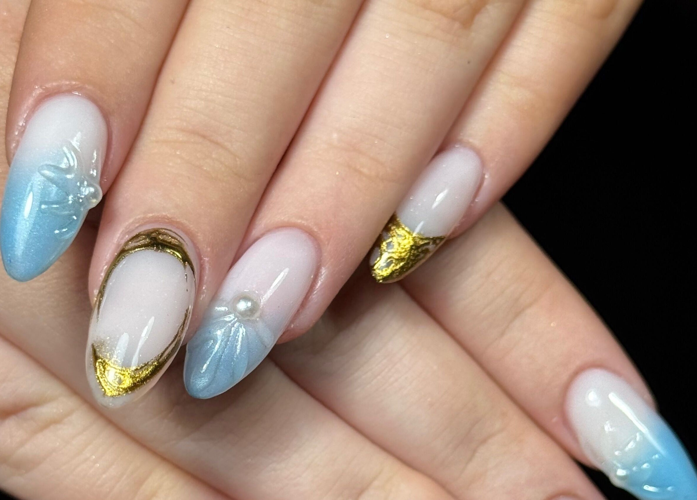 Elegant blue and gold nail art at Nails by Estee in Horsham, England, GB, showcasing intricate design.