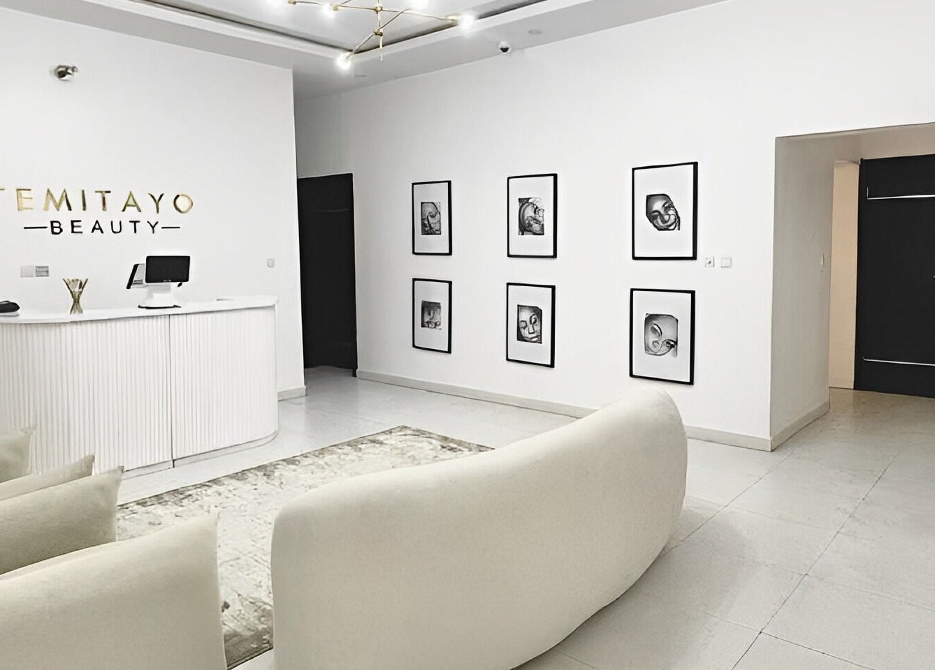 Reception area of Temitayo Beauty in Lekki, Lagos, NG featuring modern decor and soft seating.