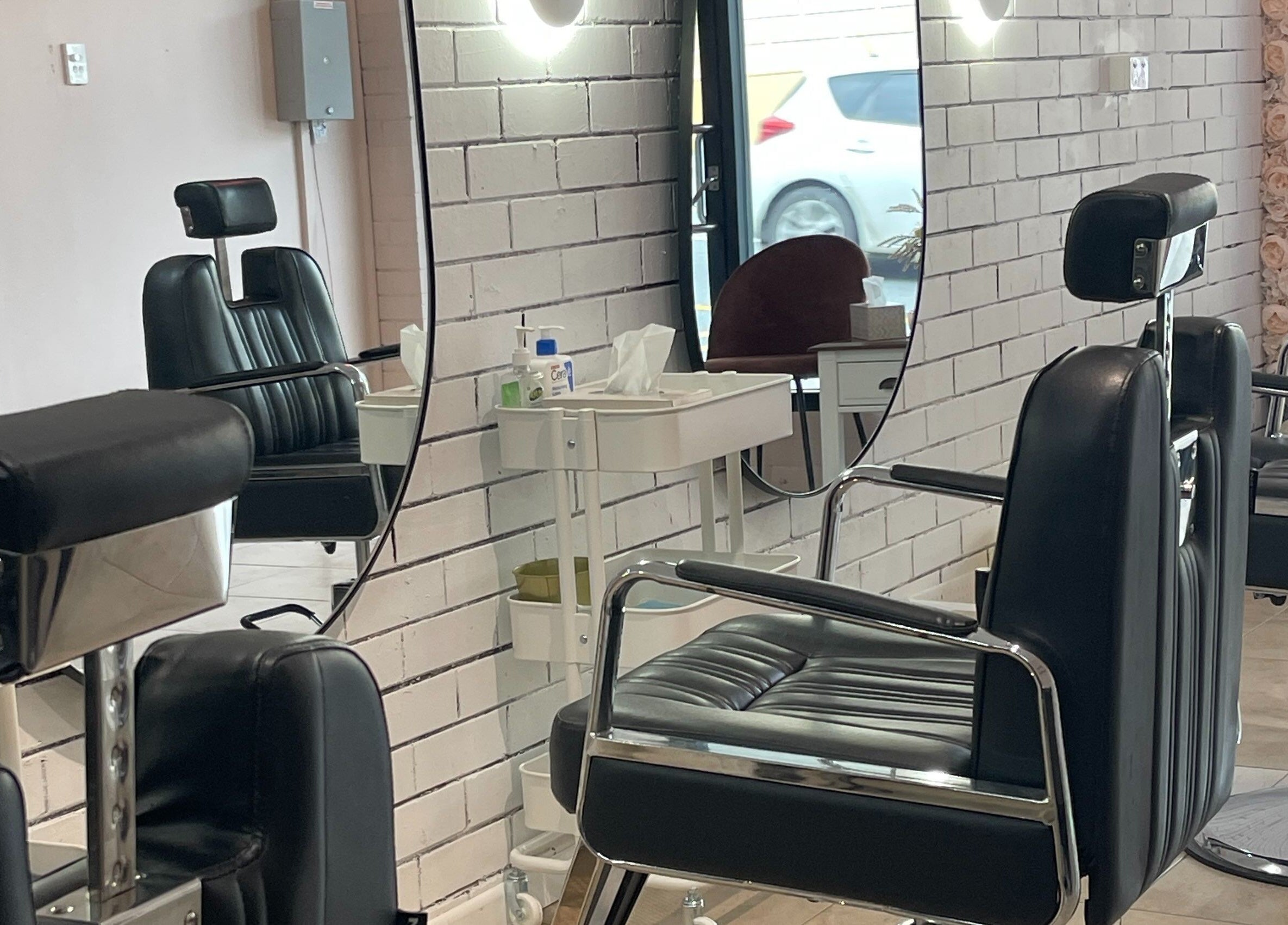 Modern salon chairs and mirrors at Bent On Brows, Gympie, Queensland, AU, highlighting a sleek interior design.