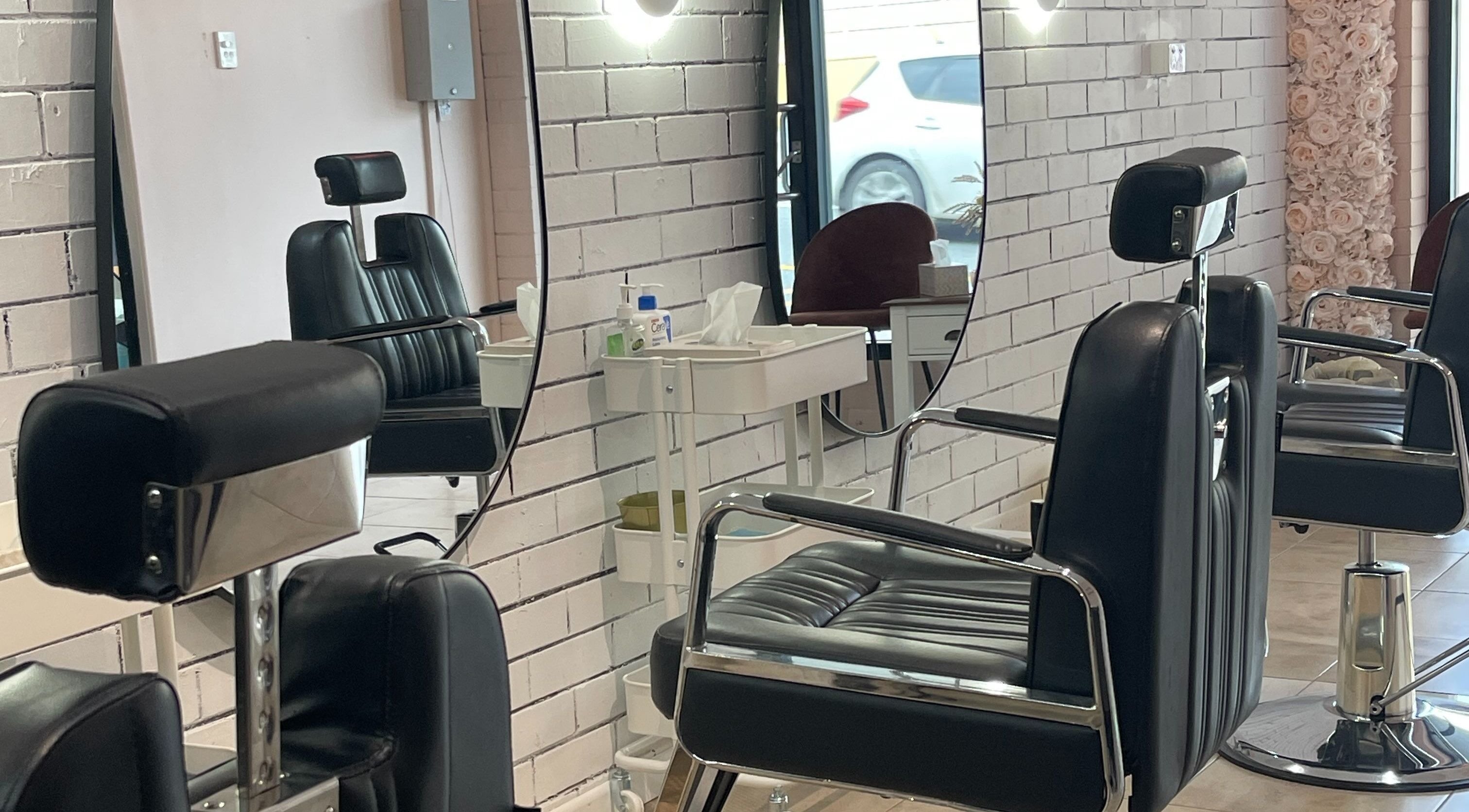 Modern salon chairs and mirrors at Bent On Brows, Gympie, Queensland, AU, highlighting a sleek interior design.