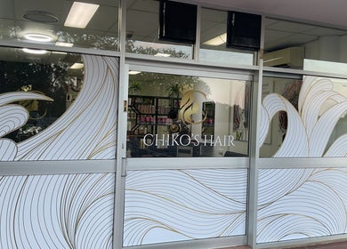 Front view of Chiko's Hair and Beauty Salon in Smithfield, Queensland, AU with stylish window design.