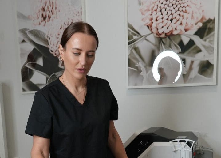 Professional at Clarion Skin, Cromer, New South Wales, AU in a calming treatment room with floral artwork.
