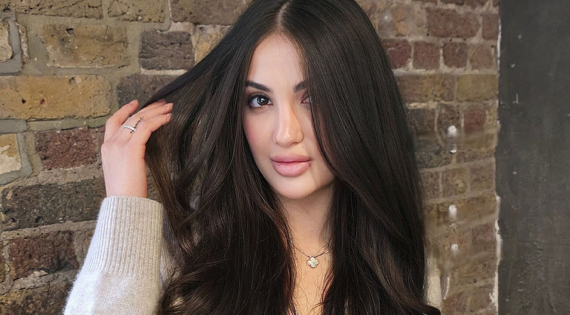 Brunette woman with sleek hairstyle at G'wan Hairstylist, London, England, GB.