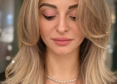 Stylish haircut at G'wan Hairstylist, London, England. Sleek layered look with soft highlights.