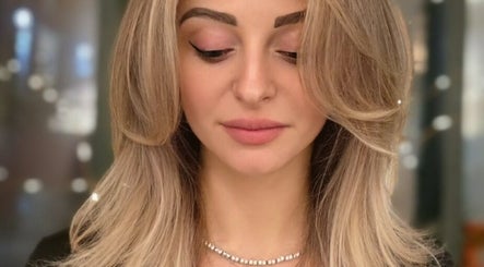 Stylish haircut at G'wan Hairstylist, London, England. Sleek layered look with soft highlights.