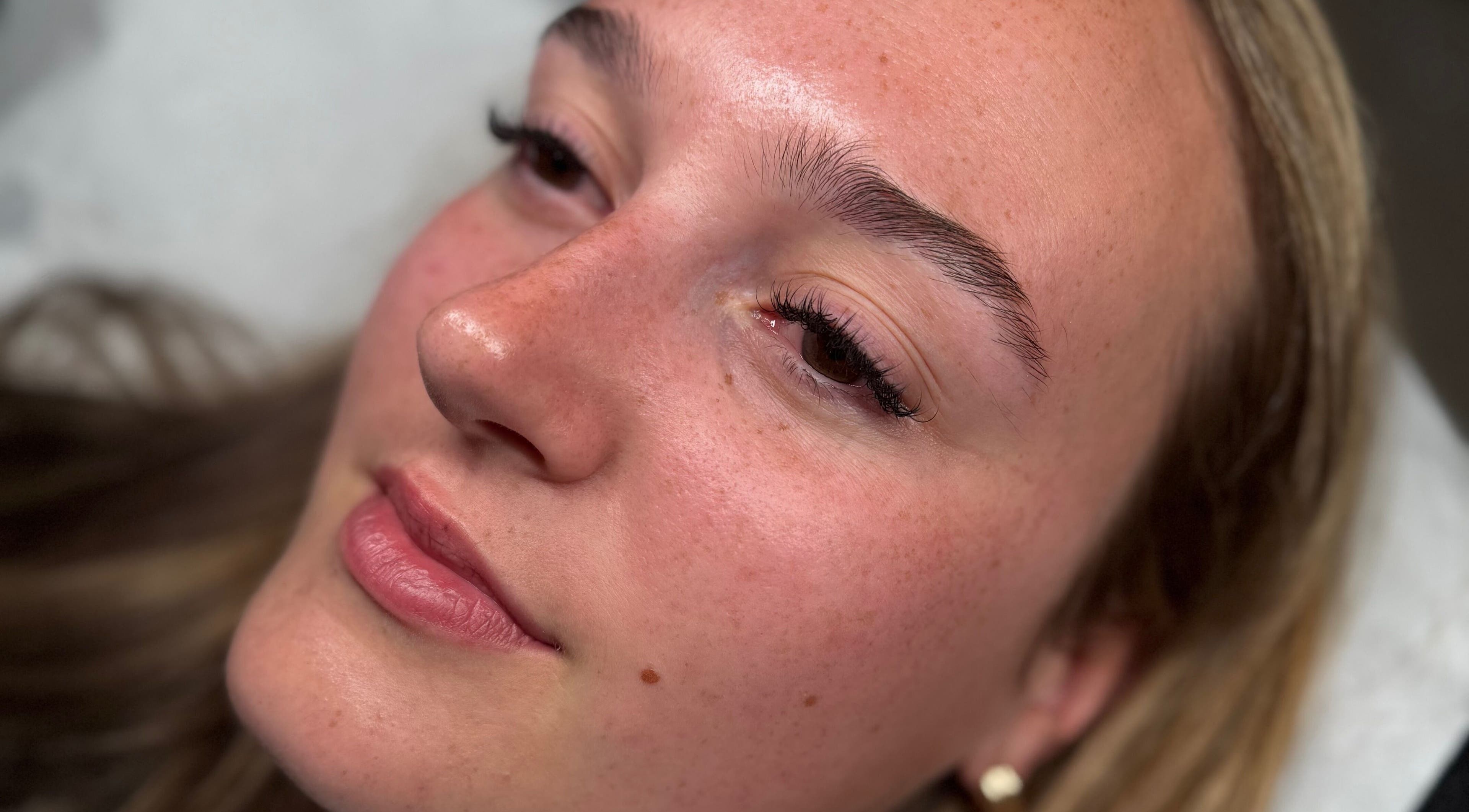 Close-up of woman's face with styled lashes at The Lash Lounge, Fakenham, England, GB.
