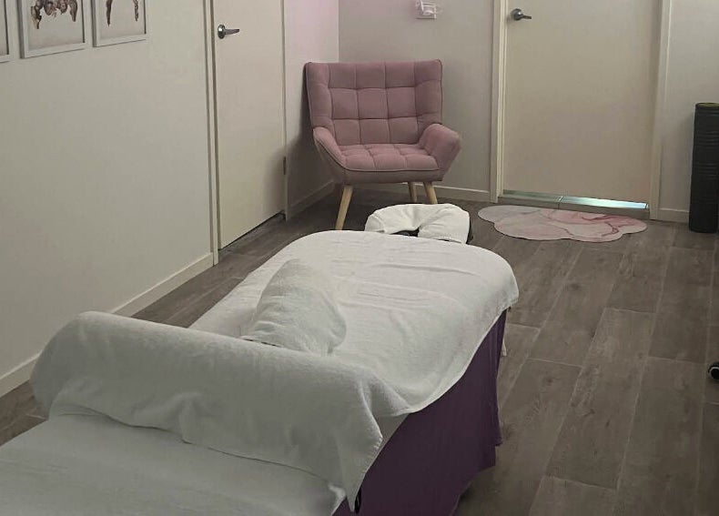 Relaxing massage room at JRT Remedial Massages, Qld, 4118, AU, featuring a cozy chair and a massage table.
