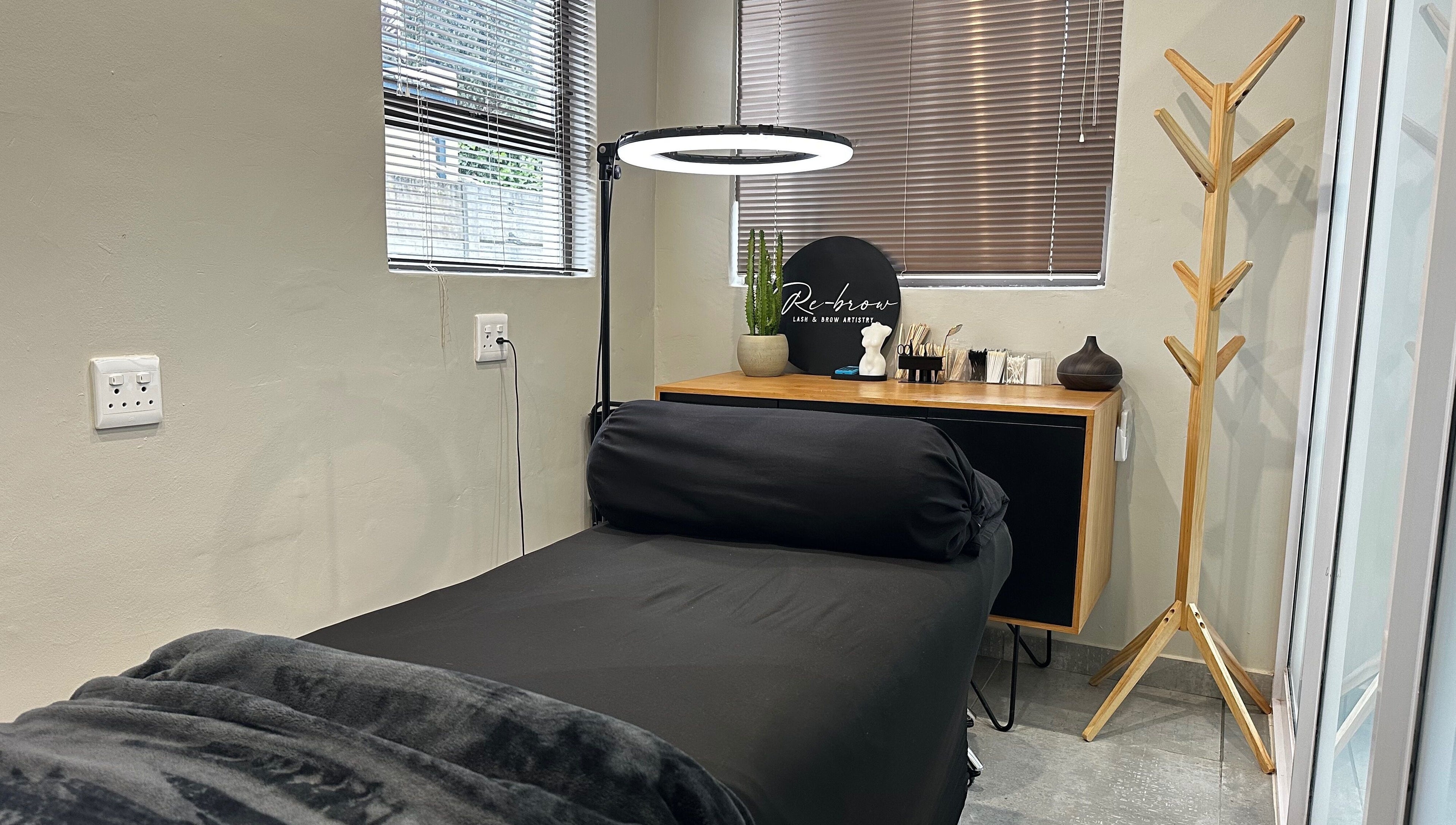 Relaxing treatment room at Re Brow Lash & Brow Artistry in Cape Town, Western Cape, ZA showcasing a plush bed.